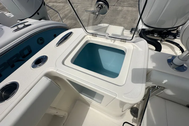 Slide: The Image of 2027 Bulls Bay 255 Center Console boat with open livewell and rod holders. - 12
