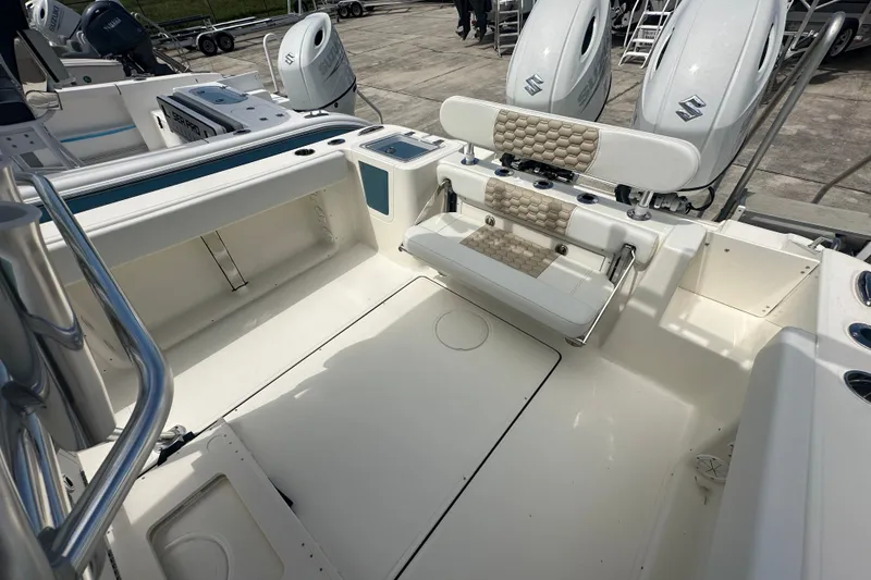 Slide: The Image of 2027 Bulls Bay 255 Center Console boat interior with seating and dual Suzuki engines. - 11