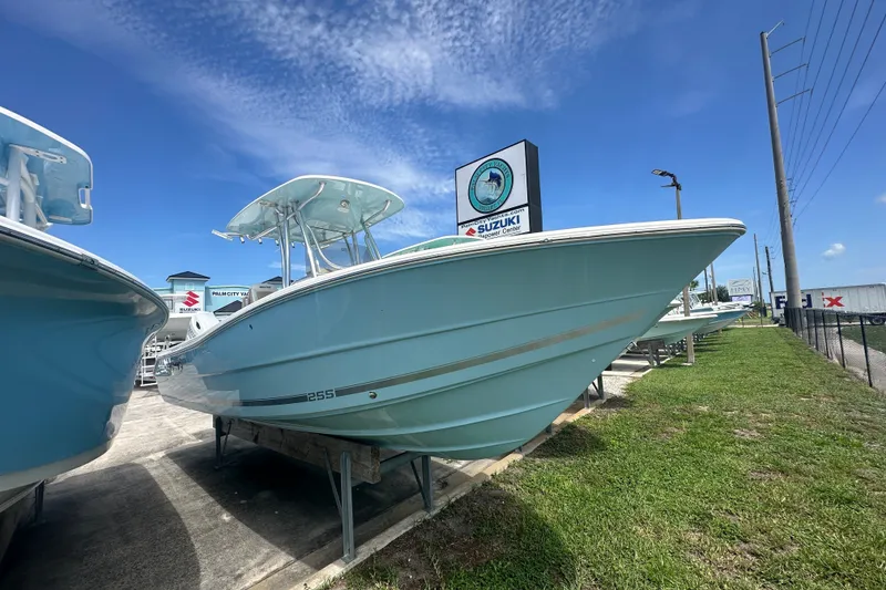 Slide: The Image of 2027 Bulls Bay 255 Center Console boat displayed outdoors under a clear blue sky. - 1