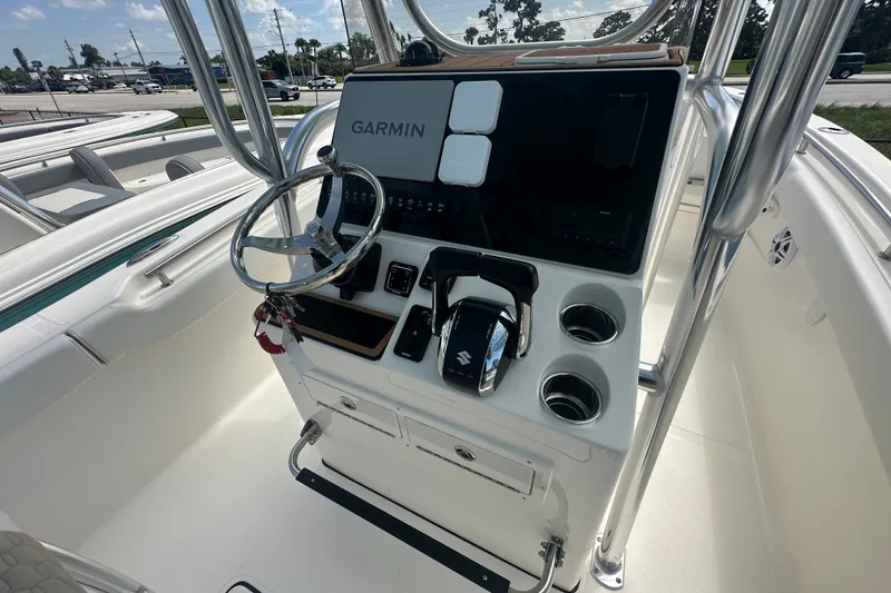 Slide: The Image of 2027 Bulls Bay 255 Center Console boat dashboard with Garmin navigation system and controls. - 5