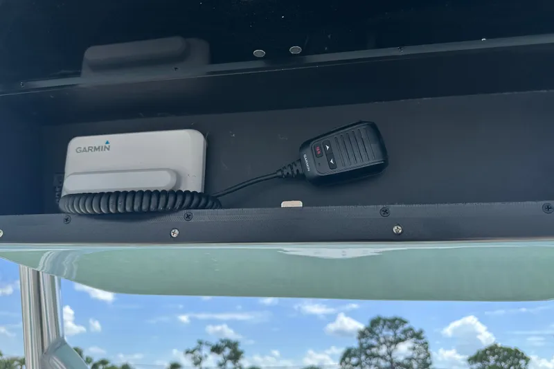 Slide: The Image of Garmin device and microphone in Bulls Bay 255 Center Console, 2027 model, against blue sky. - 6