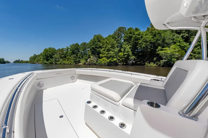 Slide: The Image of The image shows the deck of a 2022 SeaHunter 38 CTS boat on a calm river. - 31