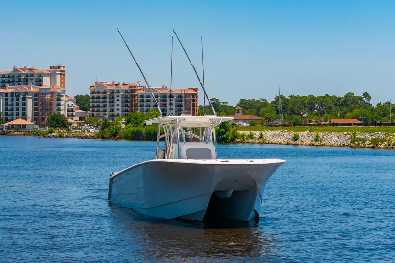 Slide: The Image of A 2022 SeaHunter 38 CTS on the water with an urban backdrop. - 43