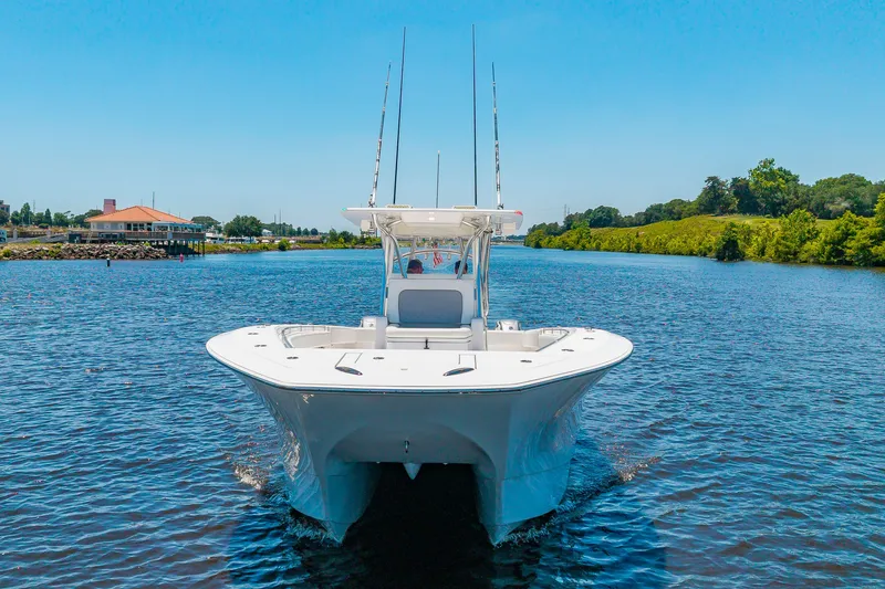 Slide: The Image of A 2022 SeaHunter 38 CTS boat cruising on calm waters under a clear sky. - 47