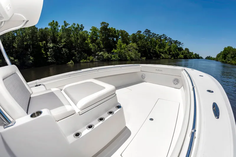 Slide: The Image of The image shows a 2022 SeaHunter 38 CTS boat on a calm river. - 32
