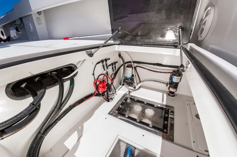 Slide: The Image of View of the engine compartment in a 2022 SeaHunter 38 CTS with various hoses and fittings. - 26