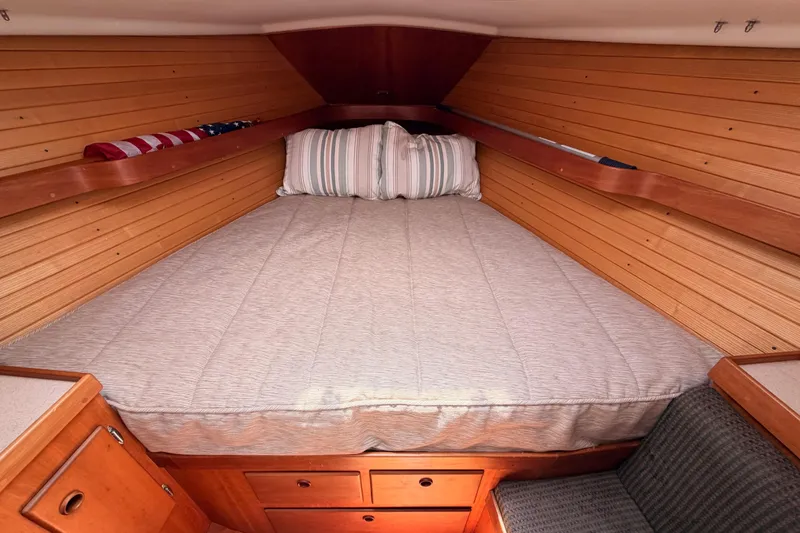 Slide: The Image of Cozy cabin interior of 2002 Sabre 362 yacht with wooden paneling and comfortable bedding. - 81