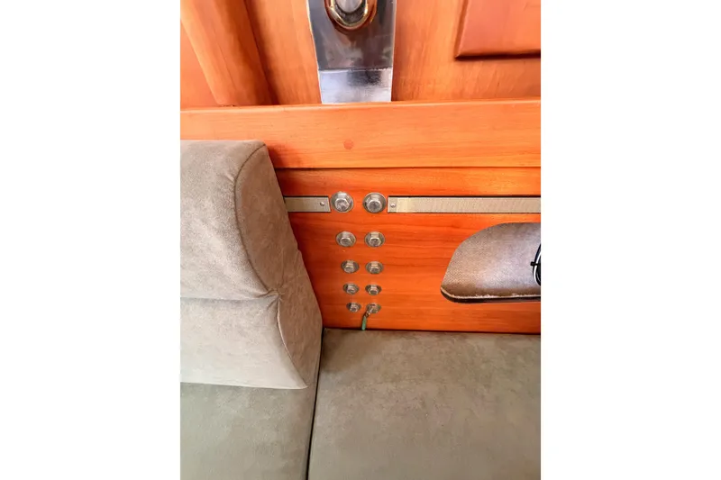 Slide: The Image of Interior view of a 2002 Sabre 362 yacht, featuring wooden paneling and seating. - 77