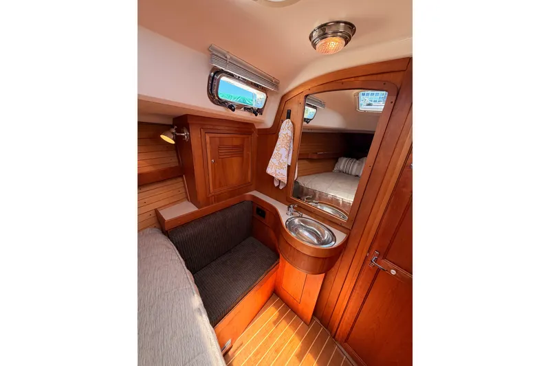Slide: The Image of Interior of 2002 Sabre 362 yacht with wooden cabinetry and cozy seating area. - 83