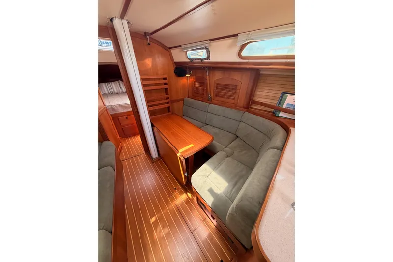 Slide: The Image of Interior of 2002 Sabre 362 sailboat with cozy seating and wooden finishes. - 65