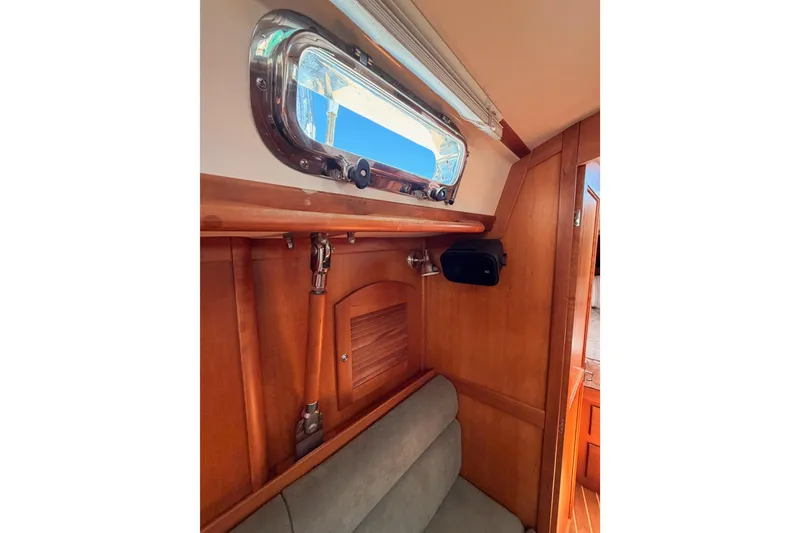 Slide: The Image of Interior of 2002 Sabre 362 sailboat with wooden paneling and porthole window. - 76