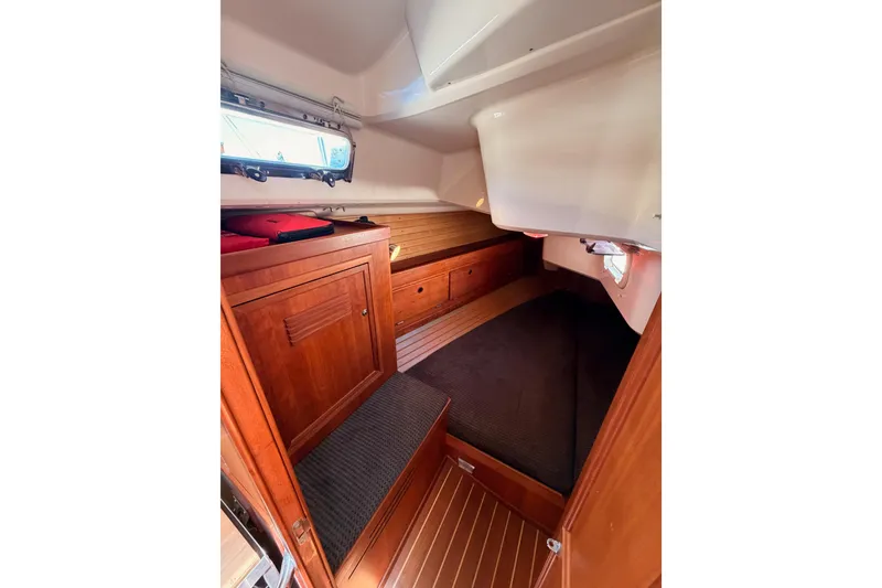 Slide: The Image of Interior cabin of 2002 Sabre 362 sailboat with wooden cabinetry and cozy sleeping area. - 52