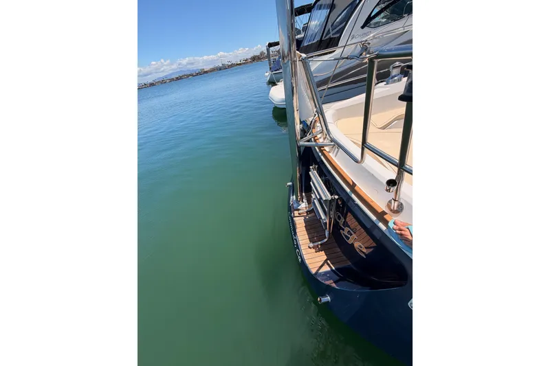 Slide: The Image of 2002 Sabre 362 yacht docked on calm water, showcasing sleek design and polished deck. - 31