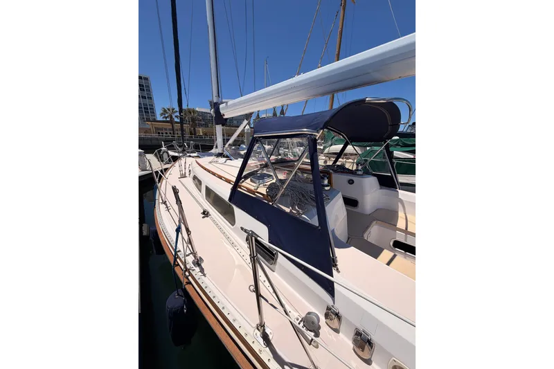 Slide: The Image of 2002 Sabre 362 sailboat docked, featuring sleek design and blue canopy. - 13