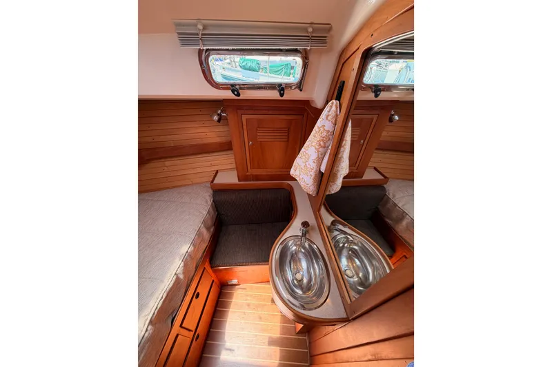 Slide: The Image of Cozy 2002 Sabre 362 yacht interior with wooden cabinetry and compact sink area. - 80