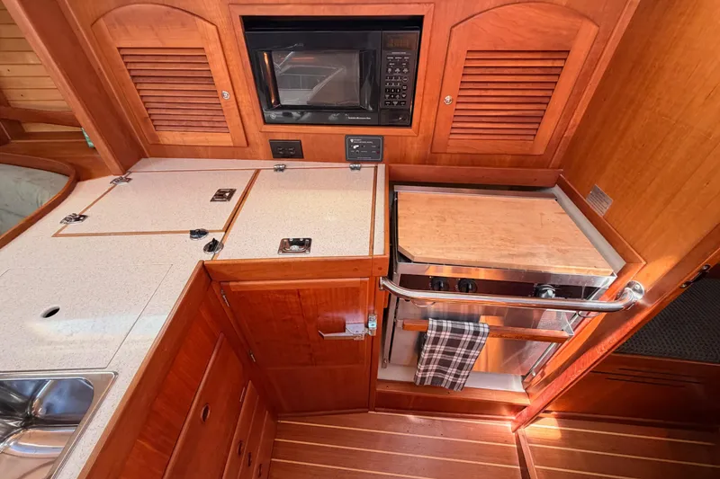 Slide: The Image of Galley kitchen in 2002 Sabre 362 sailboat with wood cabinetry and modern appliances. - 45