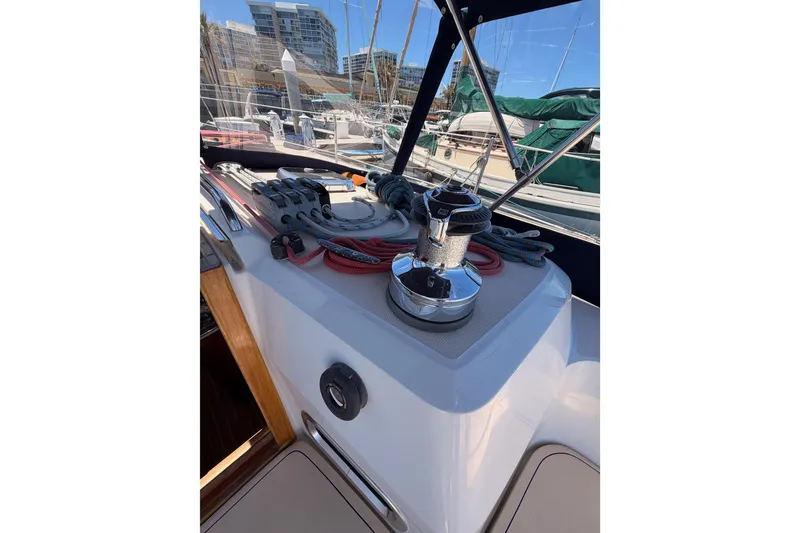 Slide: The Image of 2002 Sabre 362 sailboat deck with winches and ropes in marina setting. - 38
