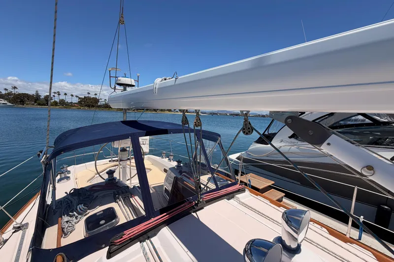 Slide: The Image of 2002 Sabre 362 sailboat docked, featuring a spacious deck and clear blue skies. - 25