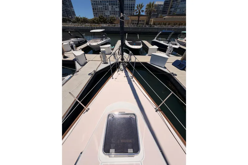 Slide: The Image of 2002 Sabre 362 sailboat docked at marina with cityscape background. - 17