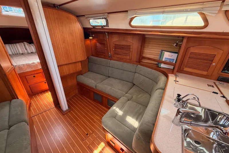 Slide: The Image of Interior of 2002 Sabre 362 sailboat with cozy seating and wooden finishes. - 64