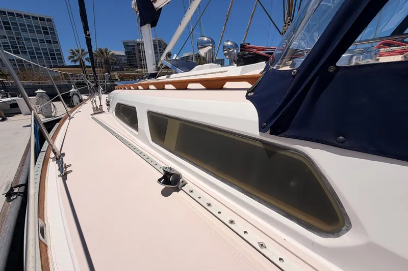 Slide: The Image of 2002 Sabre 362 sailboat docked, showcasing sleek deck design and modern fittings. - 14