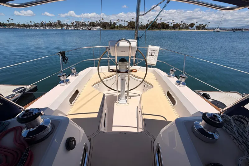 Slide: The Image of Cockpit view of 2002 Sabre 362 sailboat with scenic marina backdrop. - 28