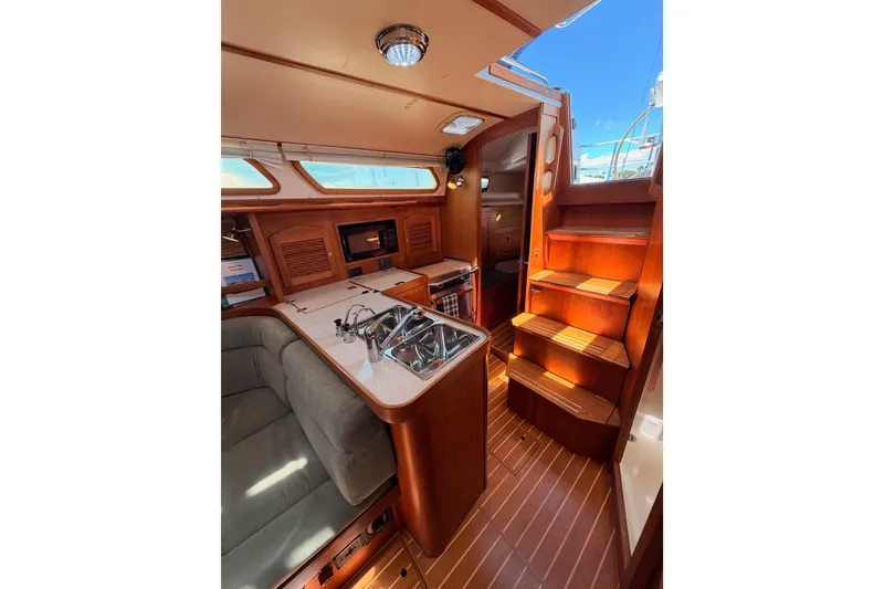 Slide: The Image of Interior of 2002 Sabre 362 sailboat with wooden cabinetry and compact kitchen area. - 42