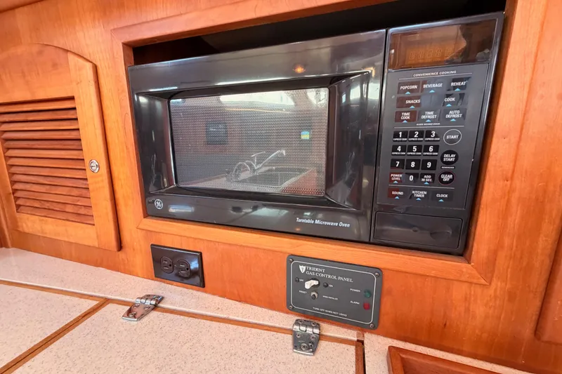 Slide: The Image of Built-in microwave in 2002 Sabre 362 yacht kitchen with control panel. - 48
