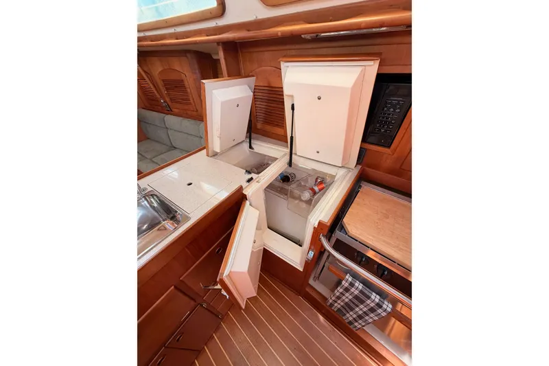 Slide: The Image of 2002 Sabre 362 yacht interior kitchen with open fridge, sink, and stove. - 46