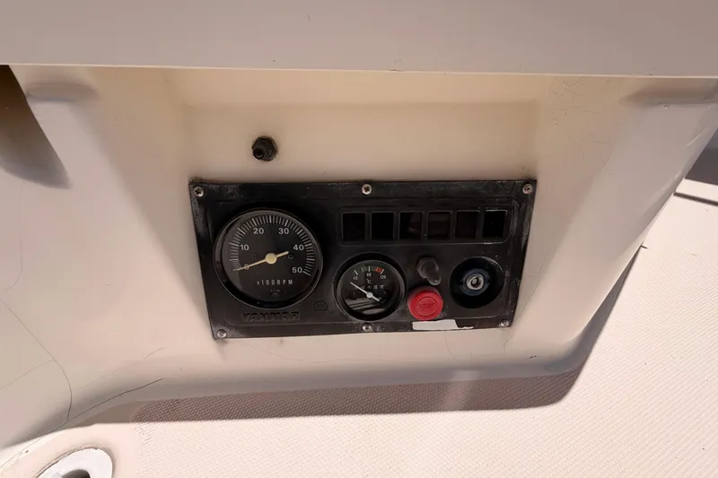 Slide: The Image of Control panel of a 2002 Sabre 362 boat, featuring gauges and switches. - 36