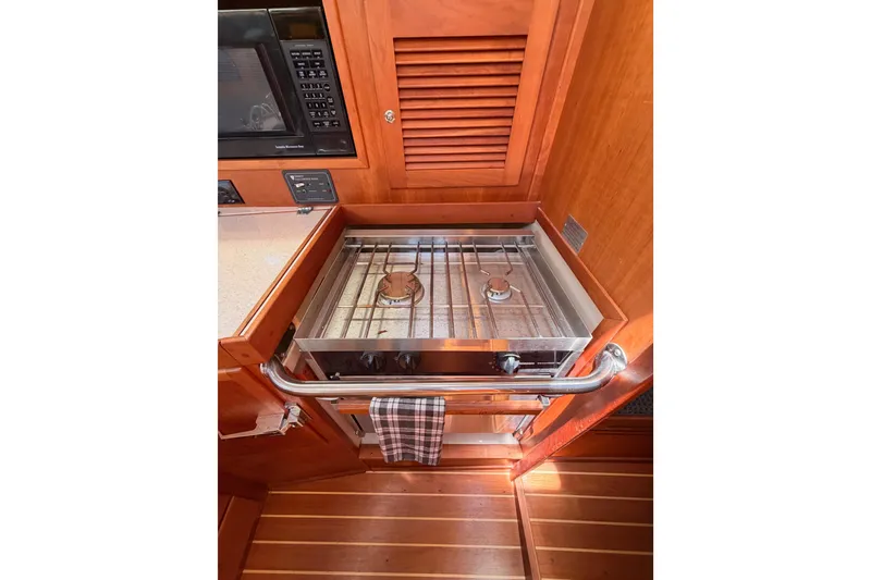 Slide: The Image of Compact kitchen area in a 2002 Sabre 362 yacht with stove and microwave. - 49