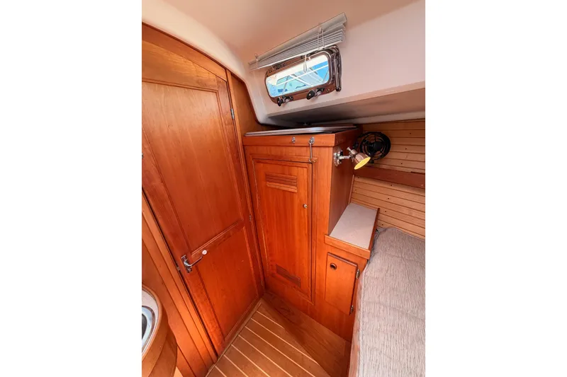 Slide: The Image of Interior of 2002 Sabre 362 sailboat featuring wooden cabinetry and cozy seating area. - 82