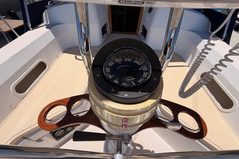 Slide: The Image of Cockpit of 2002 Sabre 362 sailboat featuring a compass and steering wheel. - 35