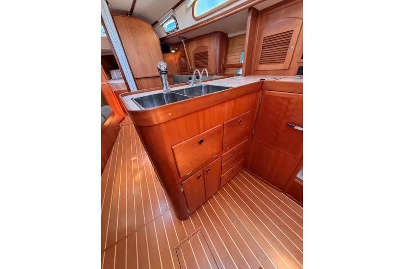 Slide: The Image of Interior of 2002 Sabre 362 yacht featuring wooden cabinetry and sleek kitchen sink. - 44