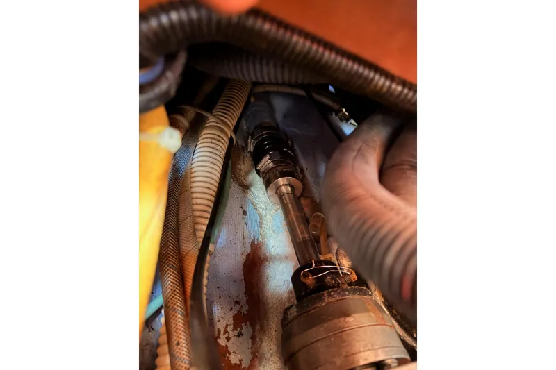 Slide: The Image of Engine compartment of a 2002 Sabre 362 with visible hoses and mechanical components. - 90