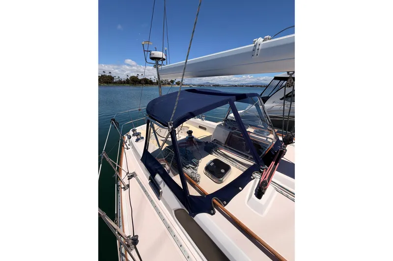 Slide: The Image of 2002 Sabre 362 sailboat with blue canopy docked on a sunny day. - 26