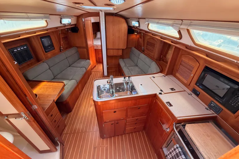 Slide: The Image of Interior of a 2002 Sabre 362 sailboat featuring a cozy cabin with wood finishes. - 40