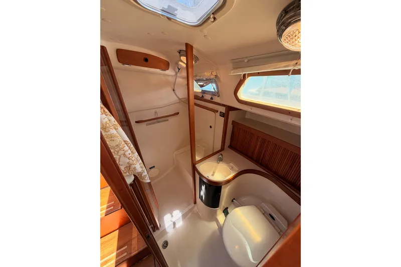 Slide: The Image of Interior of 2002 Sabre 362 yacht bathroom with wooden accents and skylight. - 58