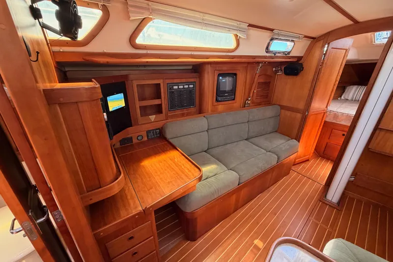 Slide: The Image of Interior of 2002 Sabre 362 sailboat with wooden finish and cozy seating area. - 63