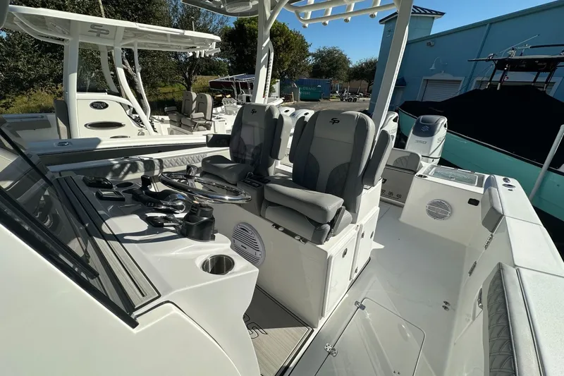 Slide: The Image of 2025 Sea Pro 322 Offshore boat interior with helm and seating area. - 15