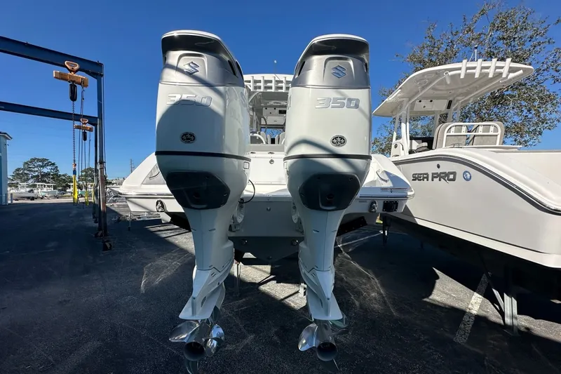 Slide: The Image of 2025 Sea Pro 322 Offshore boat with dual 350 horsepower engines, docked outdoors. - 2