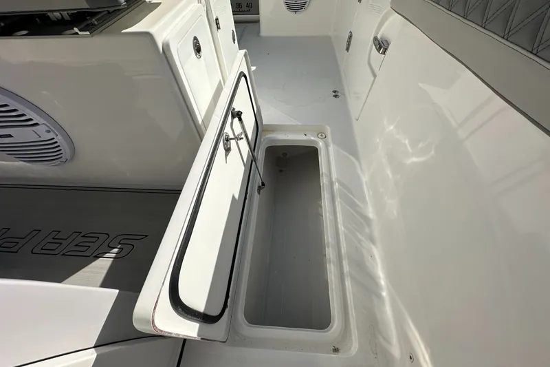 Slide: The Image of 2025 Sea Pro 322 Offshore boat interior with open storage compartment. - 16