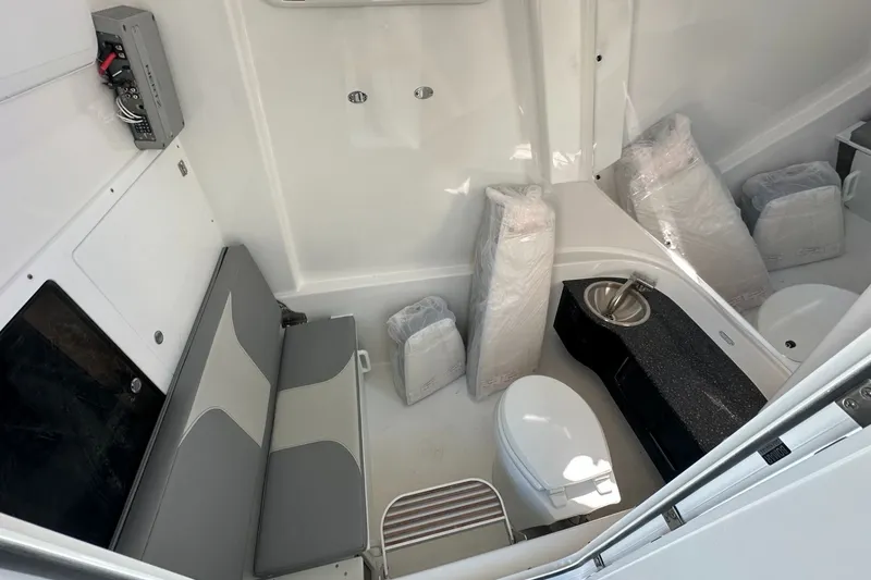 Slide: The Image of Interior of 2025 Sea Pro 322 Offshore boat with seating, toilet, and sink. - 7