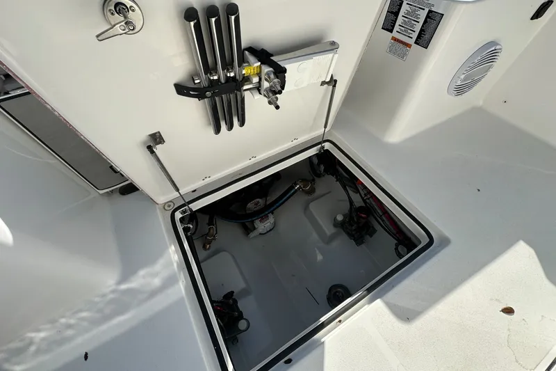Slide: The Image of Open hatch on 2025 Sea Pro 322 Offshore boat, showing interior storage and equipment. - 23