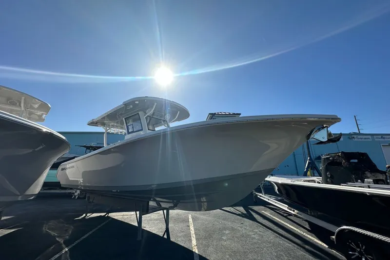 Slide: The Image of 2025 Sea Pro 322 Offshore boat under bright sun in a marina setting. - 1