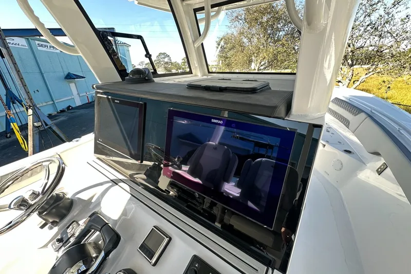 Slide: The Image of 2025 Sea Pro 322 Offshore boat dashboard with advanced navigation displays and controls. - 6