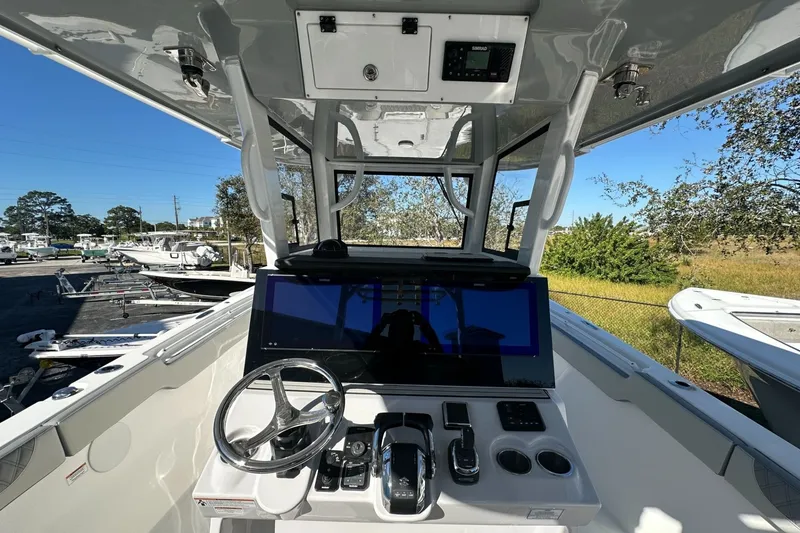 Slide: The Image of Helm of 2025 Sea Pro 322 Offshore boat with modern controls and steering wheel. - 4
