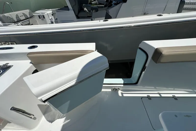 Slide: The Image of 2025 Sea Pro 292 Offshore boat interior with seating and storage compartments. - 14
