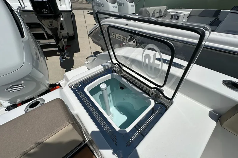 Slide: The Image of 2025 Sea Pro 292 Offshore boat with open livewell and Suzuki outboard motor. - 13