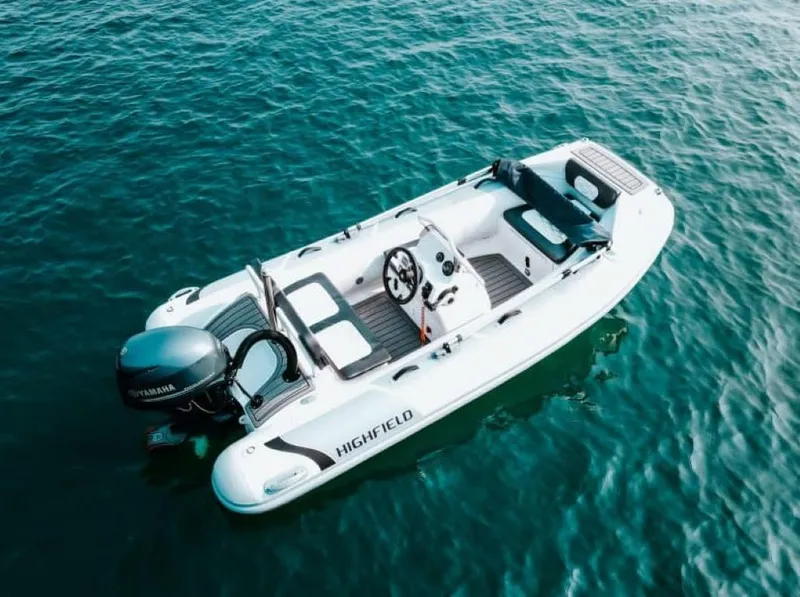 Slide: The Image of 2024 Highfield Sport 360 boat on clear blue water. - 2